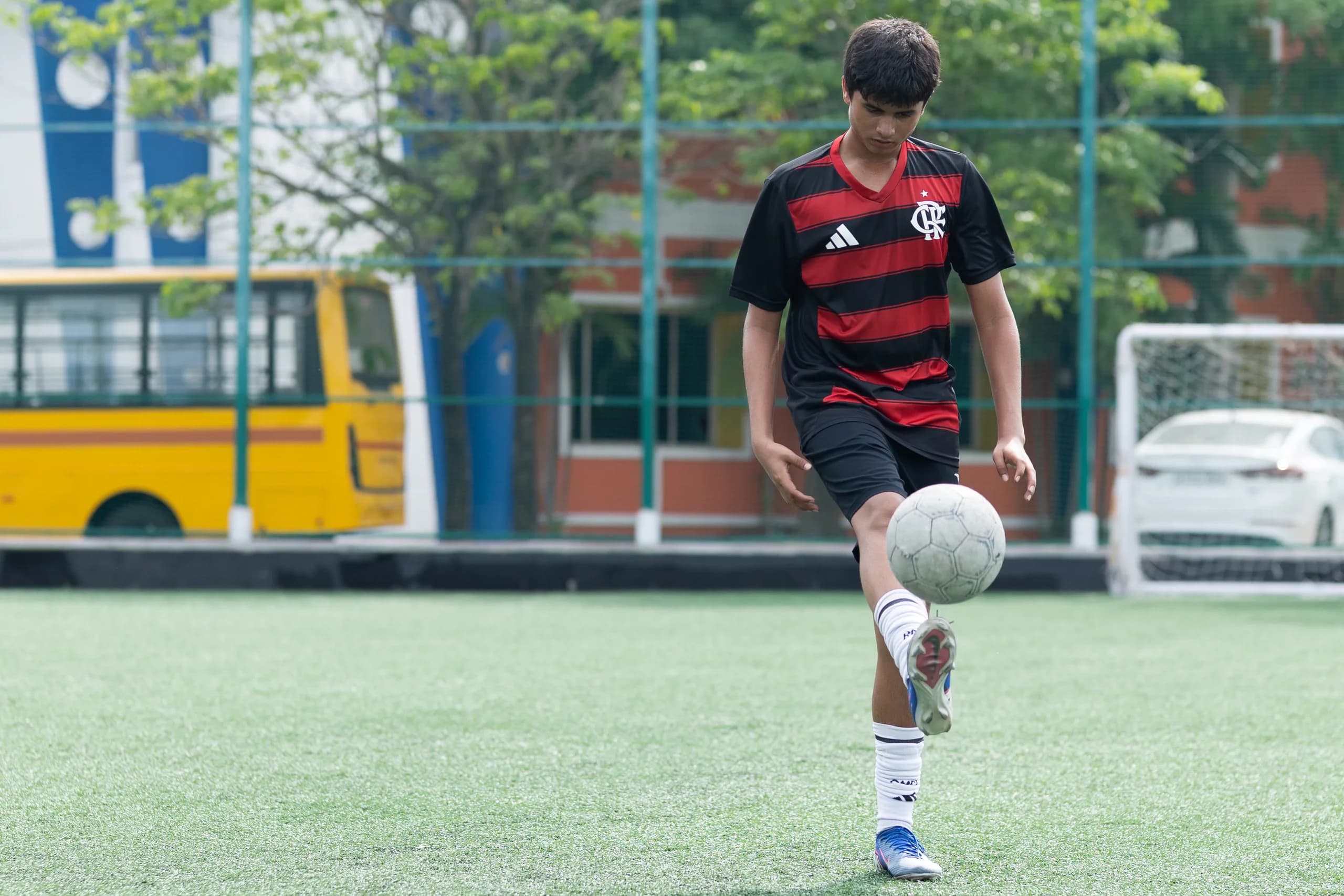 Boys sprinting across the football field during a competitive match