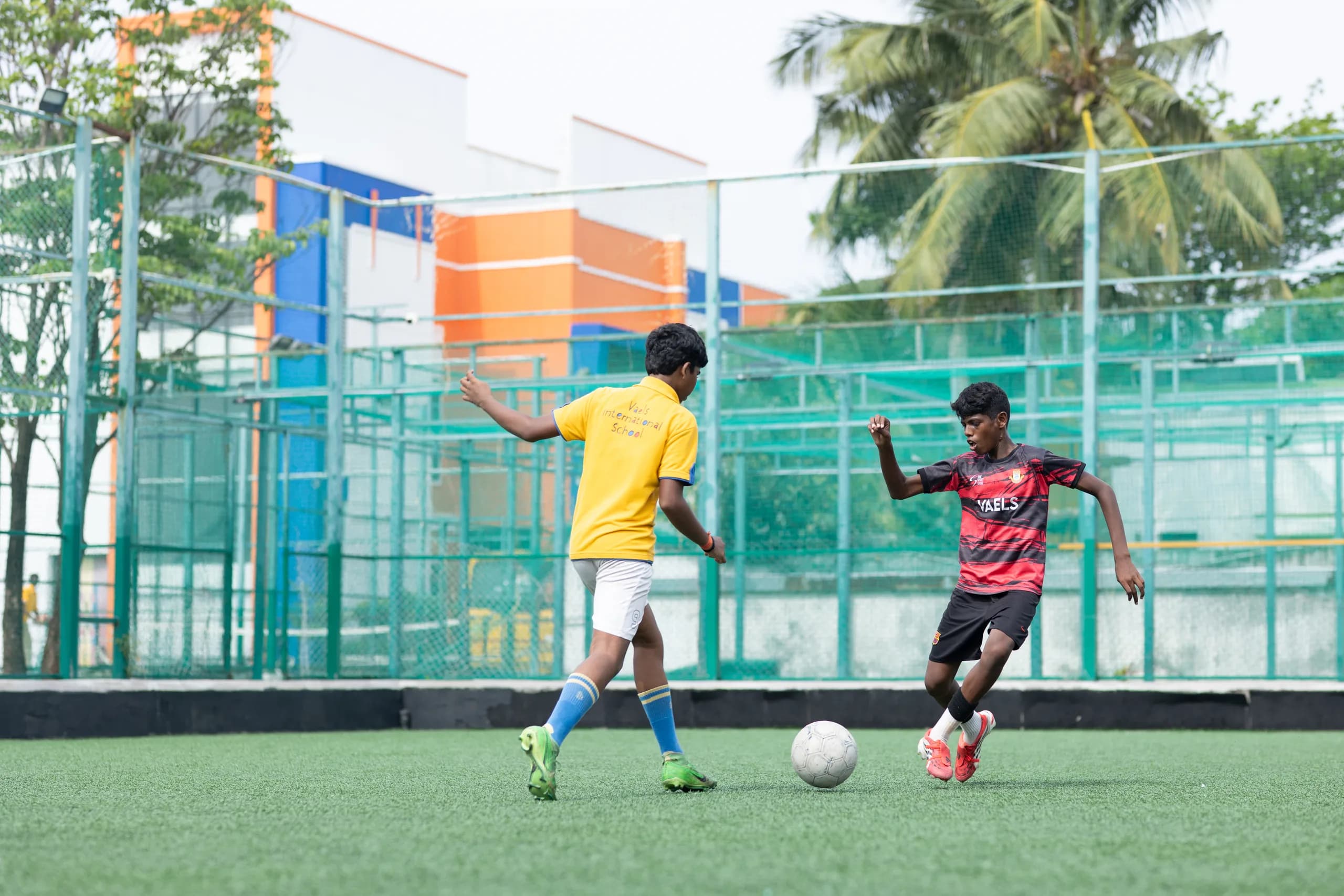 Boys football players demonstrating team spirit during a match