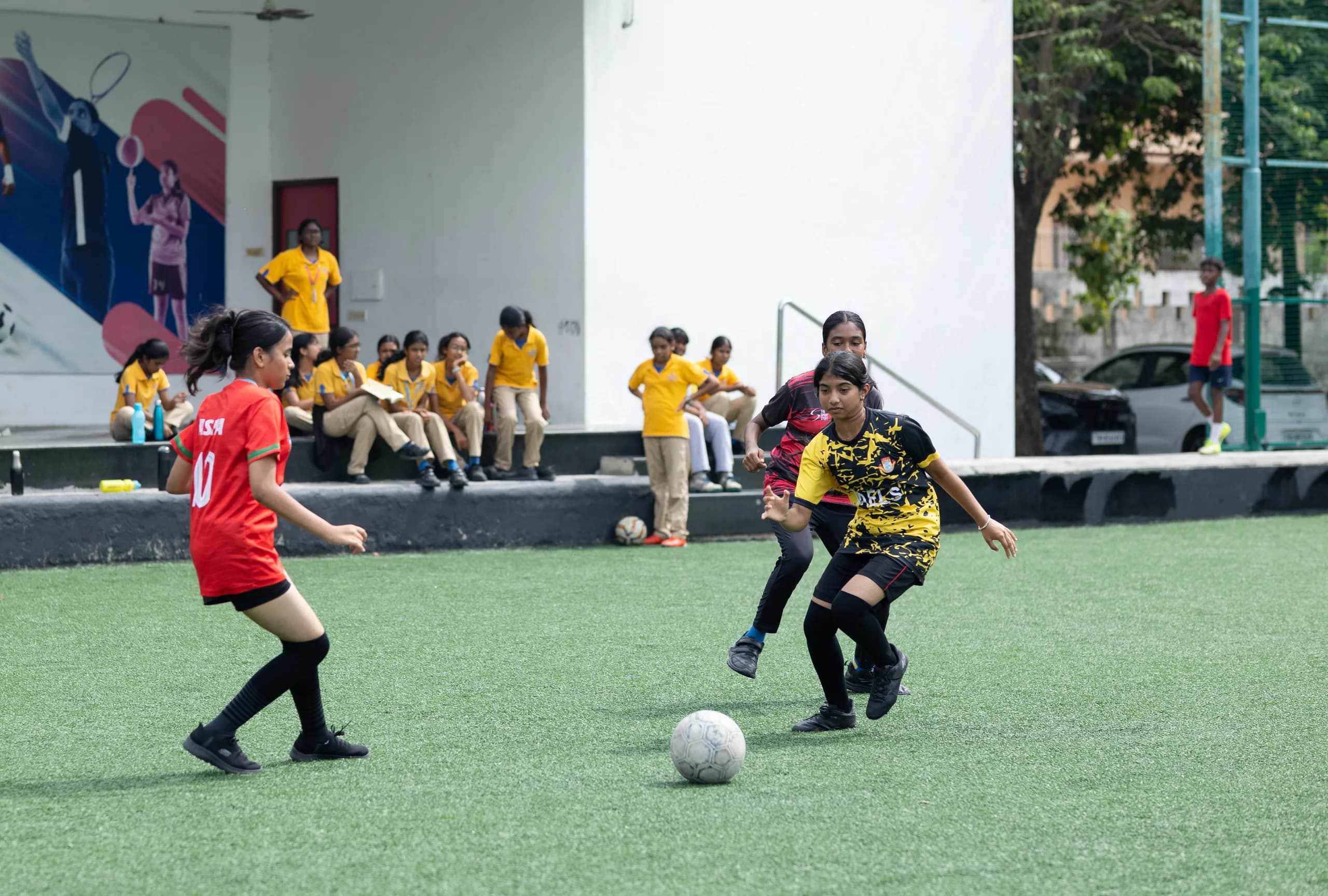 Girls football team at kick-off on the Vaels school field