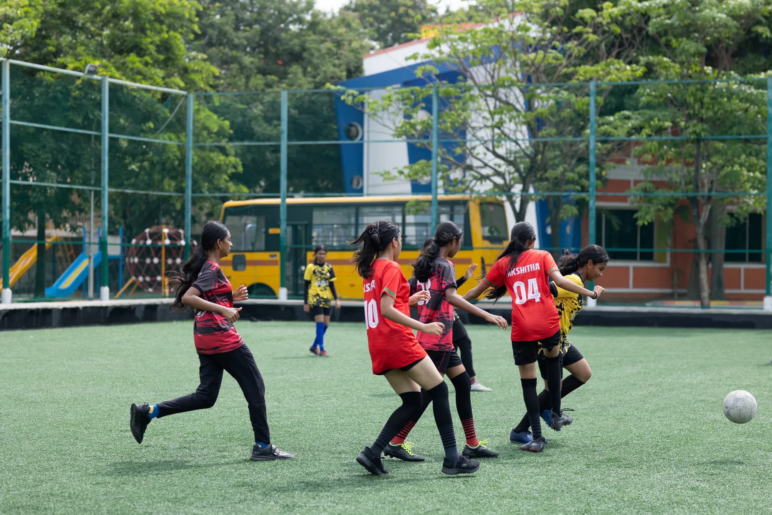 Girls football midfield action during a school tournament