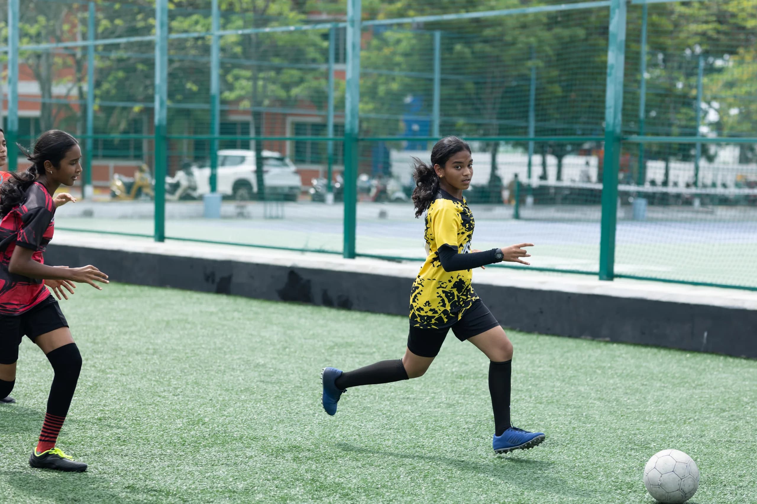 Girls challenging for the ball during a football match at Vaels