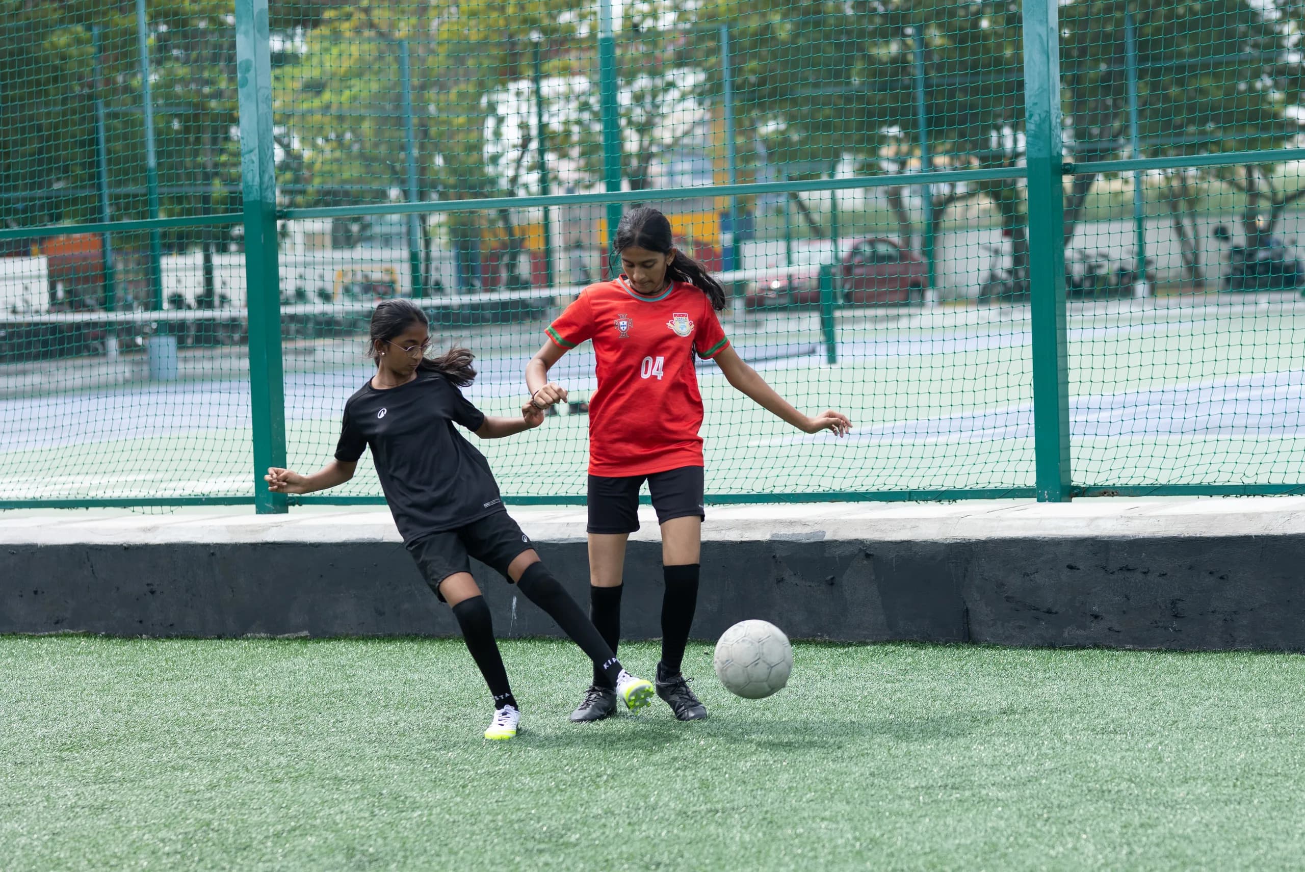A girls football player showing speed and skill during a match