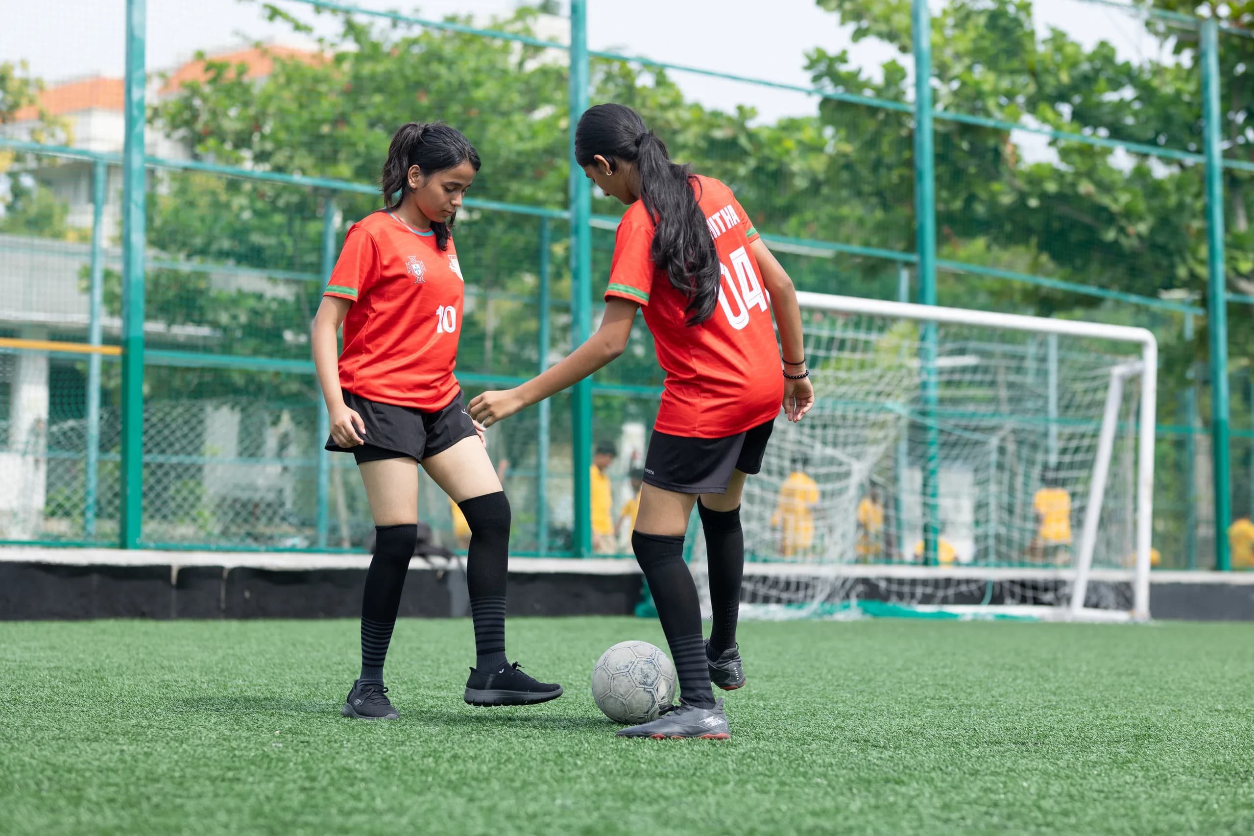 Girls football players showing energy towards the final whistle