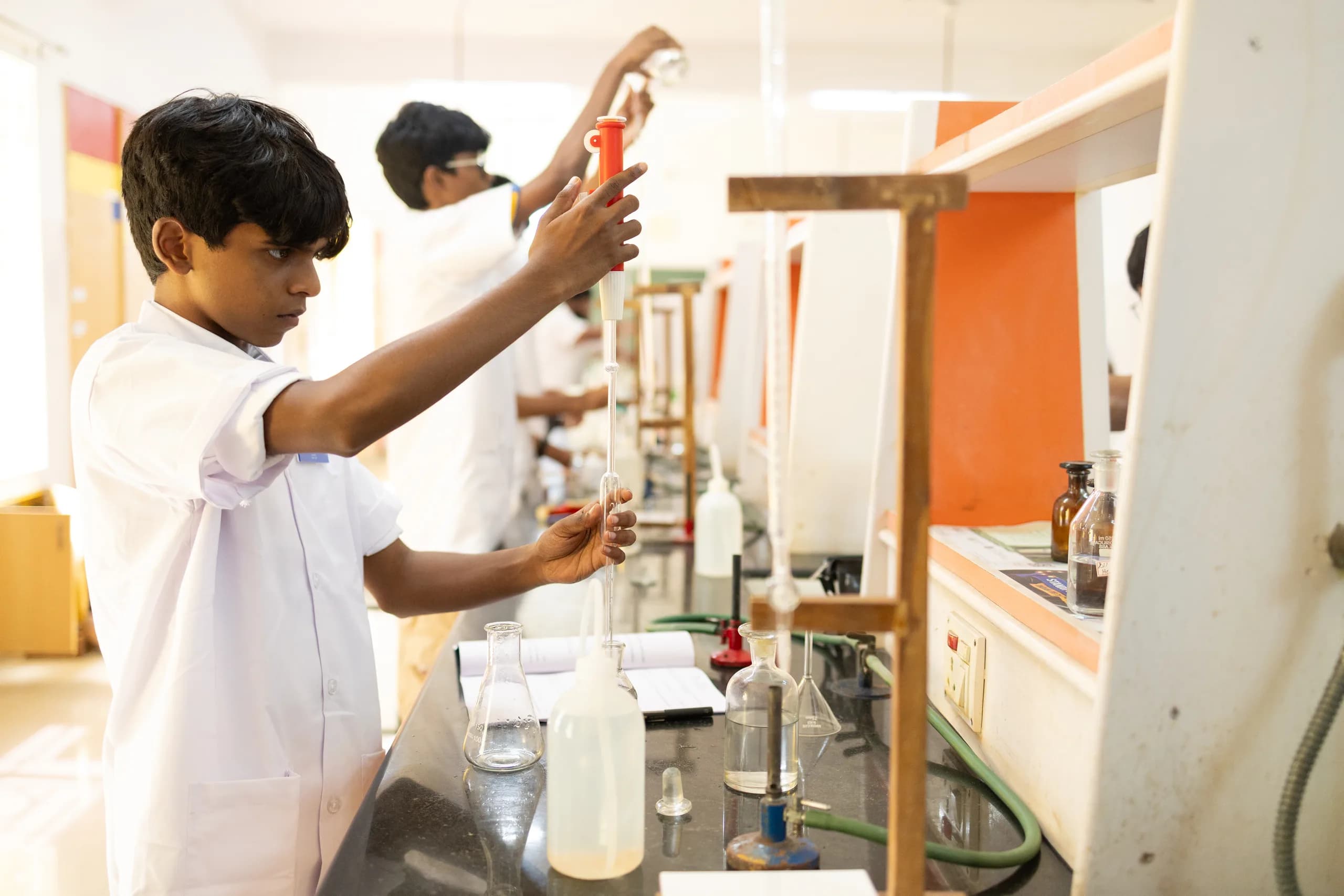Students demonstrating precision in a chemistry lab experiment