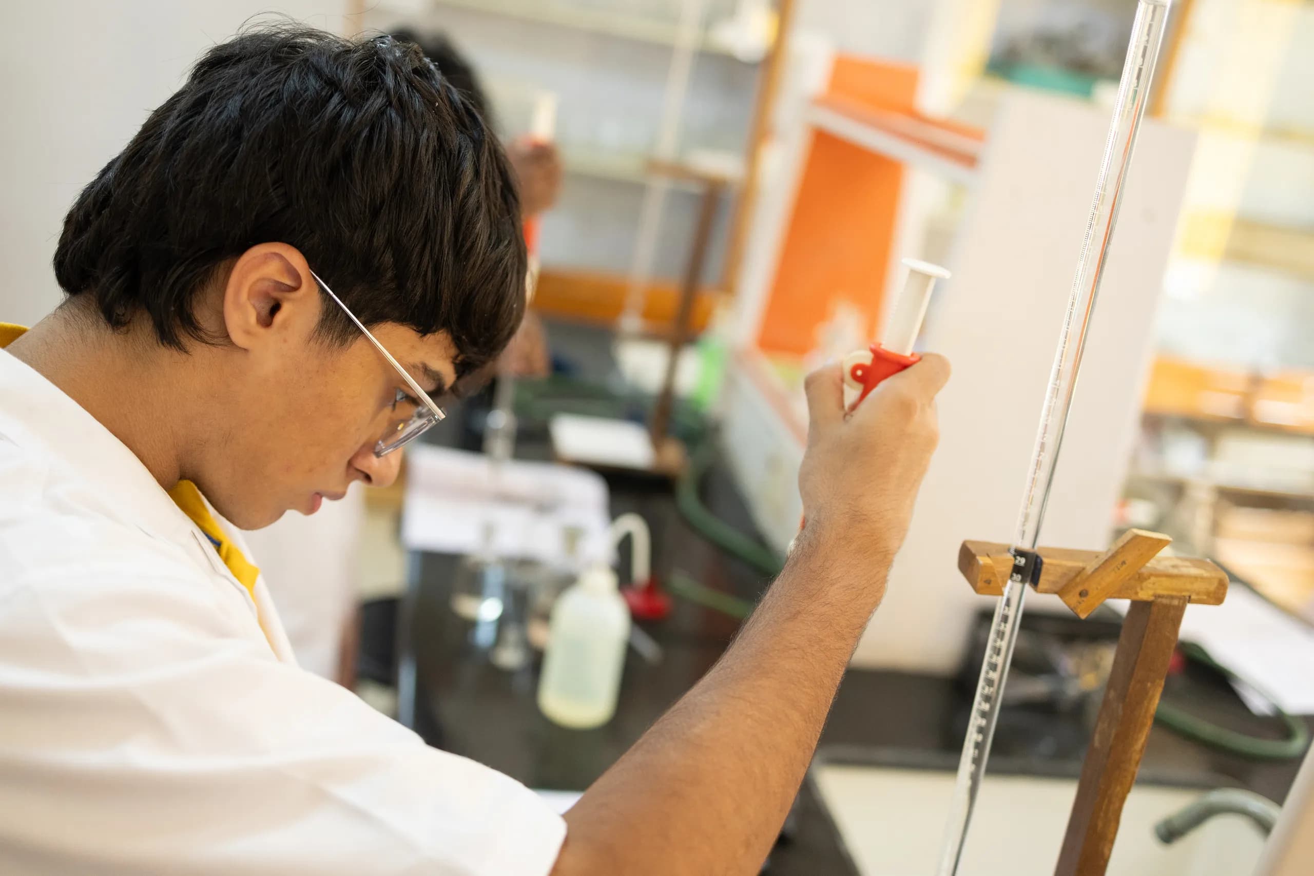 Students applying scientific rigor in chemistry laboratory work