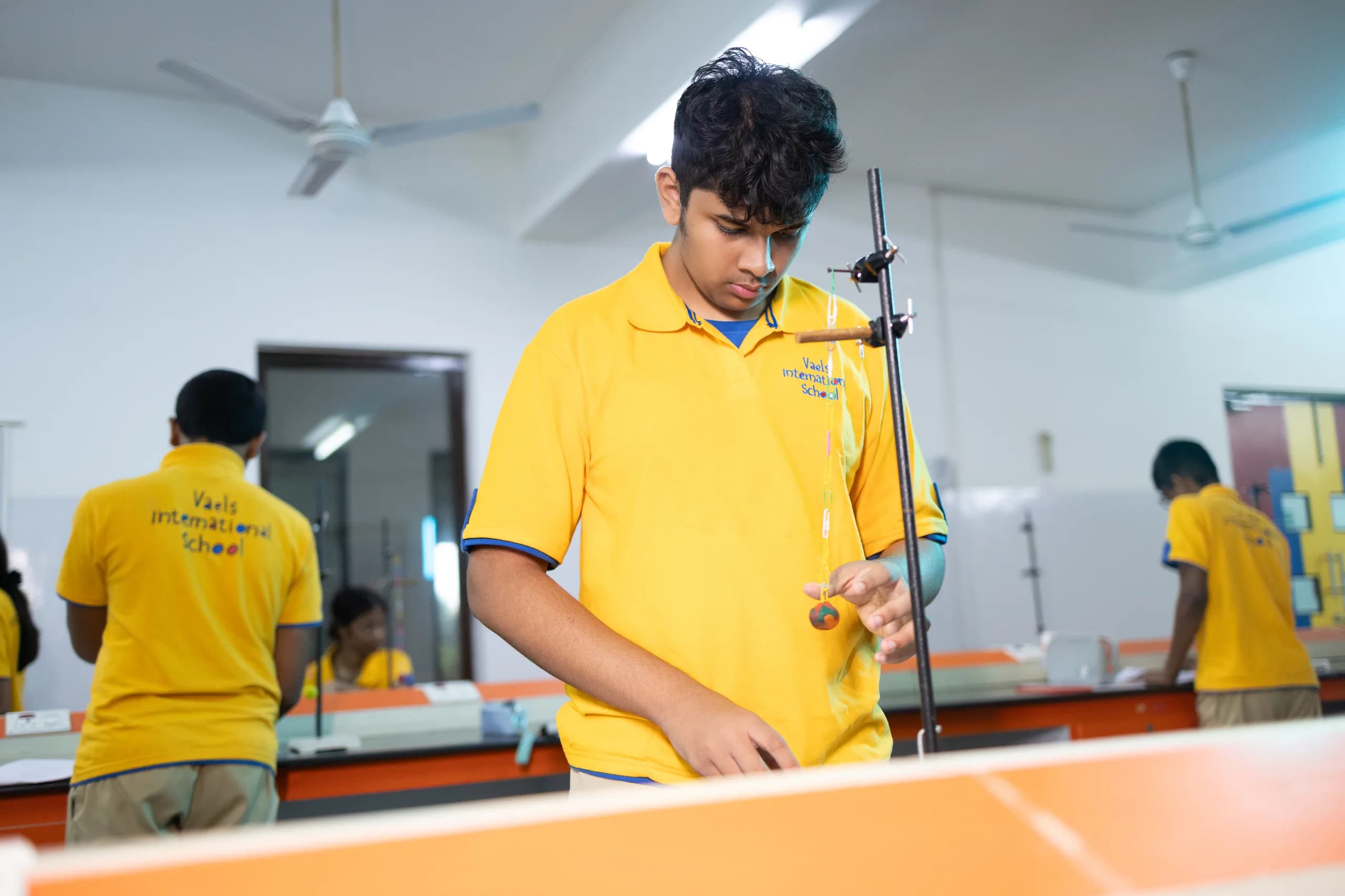 Physics students applying theory to practical lab work at Vaels