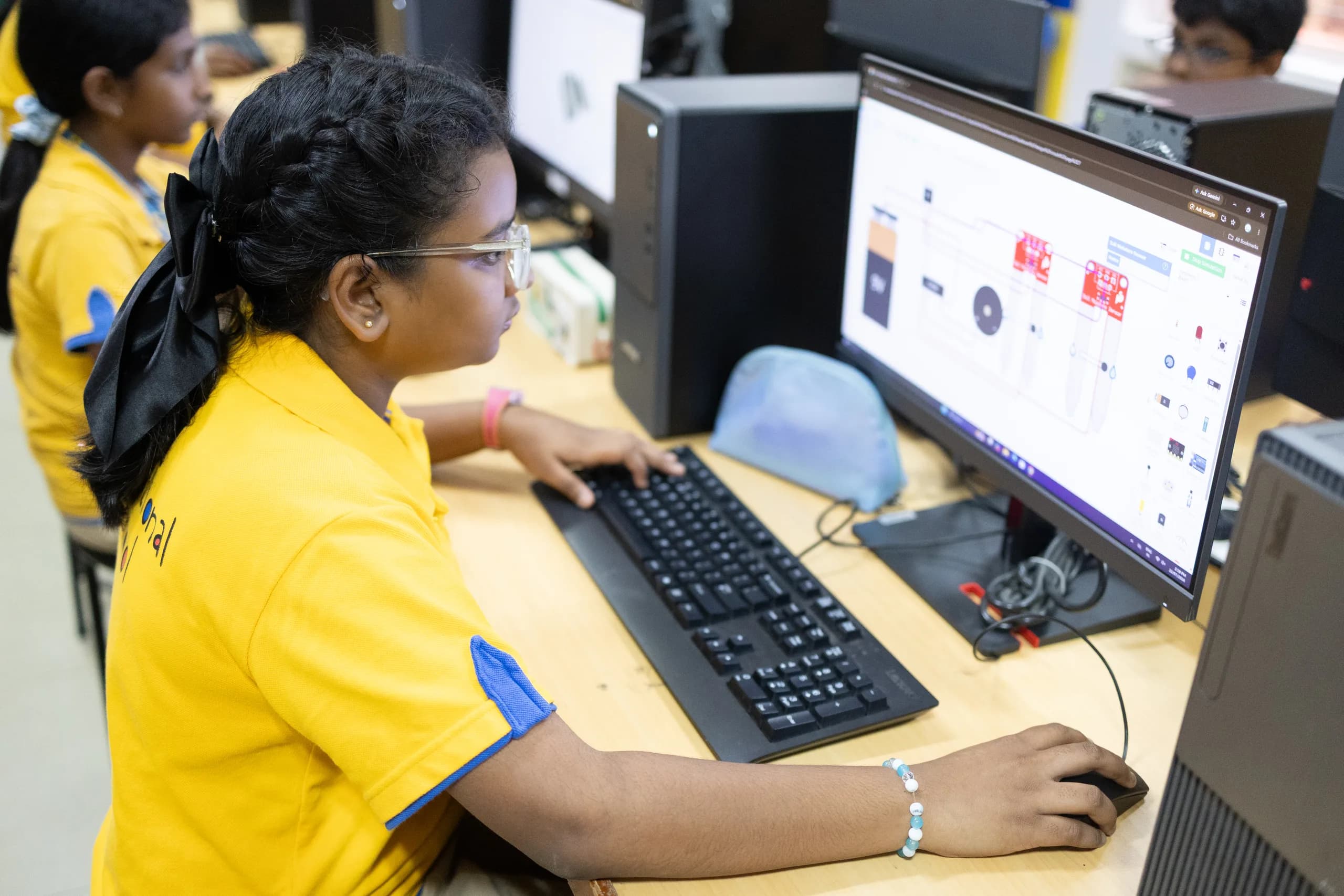 Students programming robots in the Vaels robotics computer lab