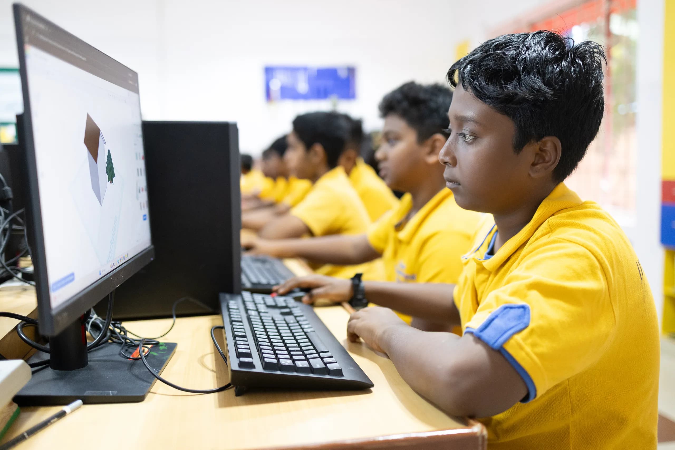 Students coding and building in the robotics lab at Vaels International School