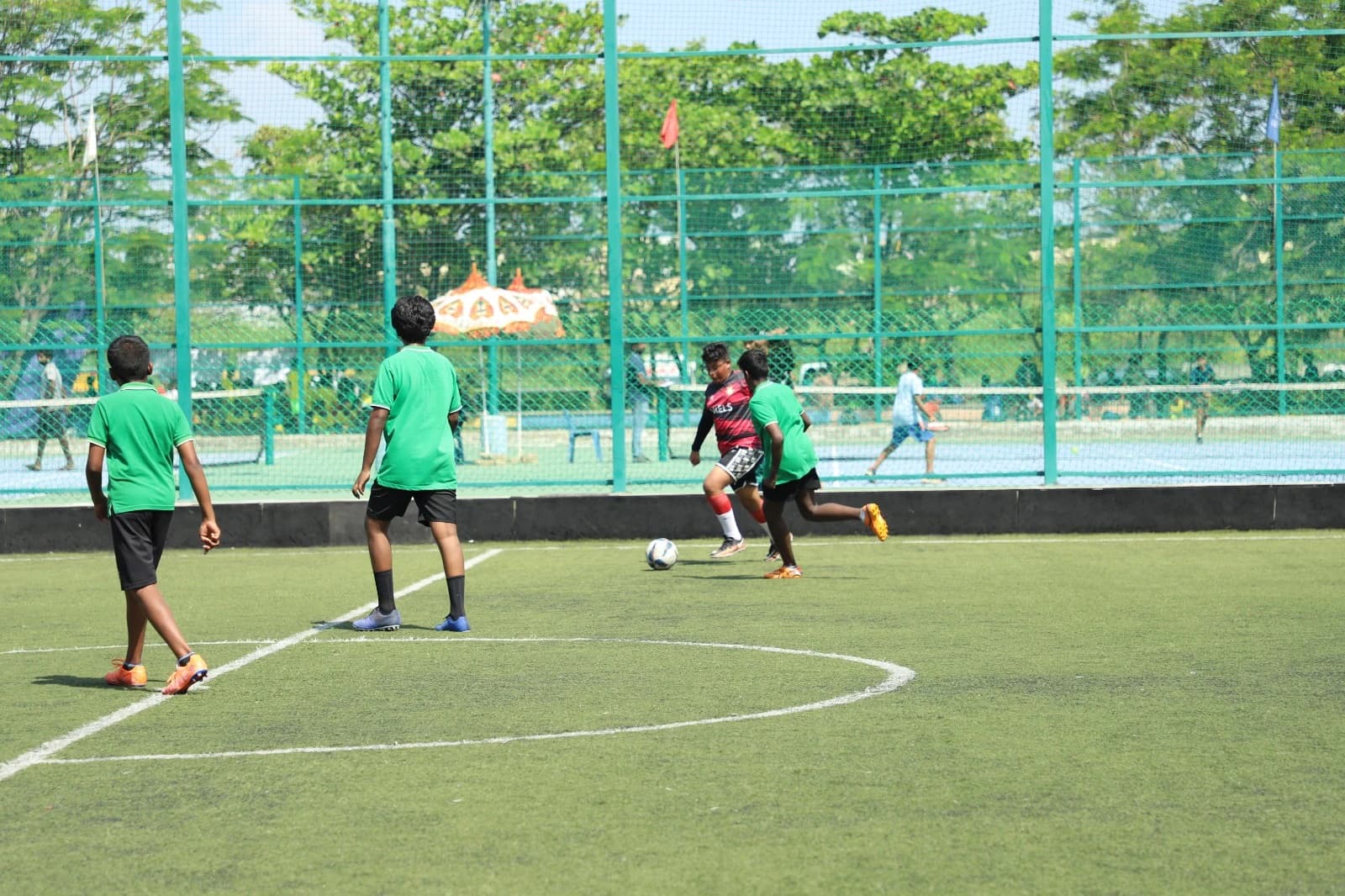 Students playing a competitive football match on outdoor field